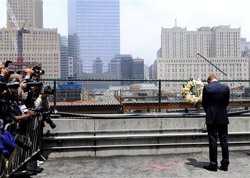 Prince Harry pauses at the World Trade Center site, as the press snaps away